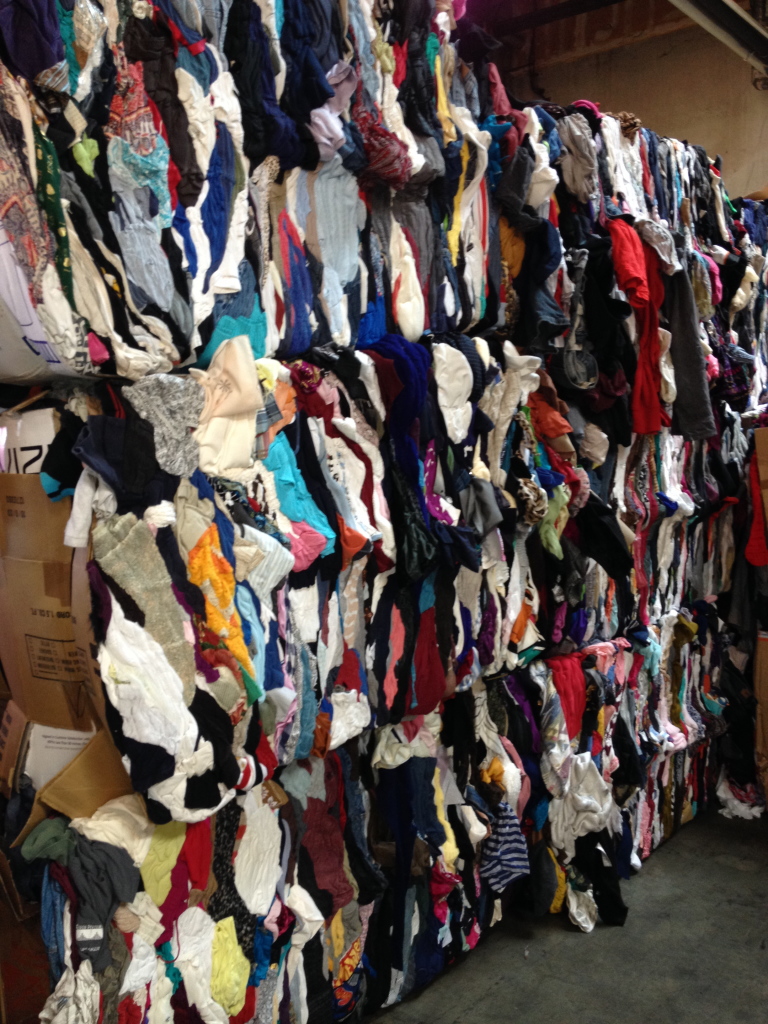 bales of torn and stained clothes